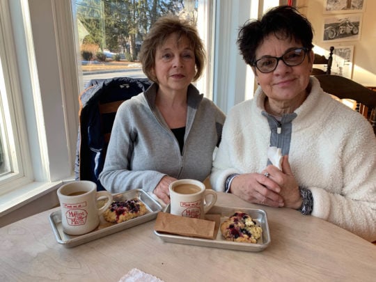 Two women at table for National Muffin Day