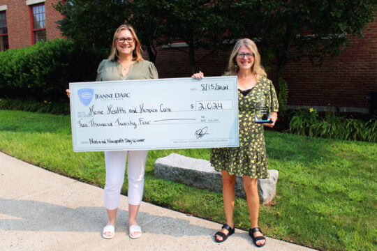 Alison Hughes, Jeanne D’Arc Credit Union’s Vice President – Community Engagement holding an oversized check for $2,024 made out to Home Health & Hospice Care with Paula J. Telage, Director of Corporate Giving at Home Health & Hospice Care.