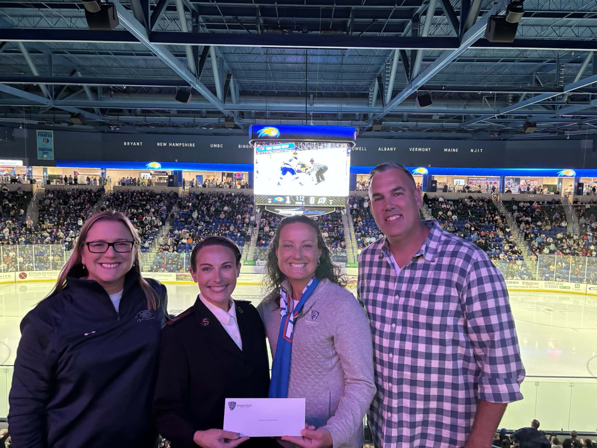 Major Amanda Krueger, Salvation Army of Greater Lowell (second from left); accepts a donation from the Steve Jones Legacy Fund, presented by Jeanne D’Arc Credit Union’s Alison Hughes, VP – Community Engagement; Larissa Thurston, President and Chief Executive Officer; Brian Collins, SVP – Chief Operating Officer (left to right).
