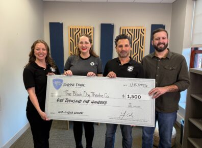 Black Dog Theatre Company board members Dusty Behner, Managing Director; Kaitlyn Smith, Secretary; Todd Coolidge, Artistic Director; and Kevin Lundy, Vice President; accept a $1,500 check from Jeanne D’Arc Credit Union for being the Q4 2025 winner of the Give-A-Click campaign on January 15, 2026.
