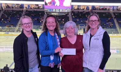 Kathryn Dame, Vice President, Branch Administration, Larissa Thurston, President & CEO, and Alison Hughes, Vice President, Community Engagement at Jeanne D’Arc Credit Union presenting a donation to Dawn Roberts, Vice President of Finance & Administration (second from the right) of Cooperative Credit Union Association - A Bed for Every Child.