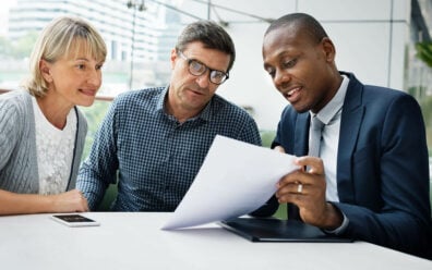 A couple discusses how personal lines of credit work with a credit union representative.