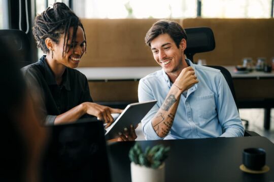 Two young business partners collaborate on a project