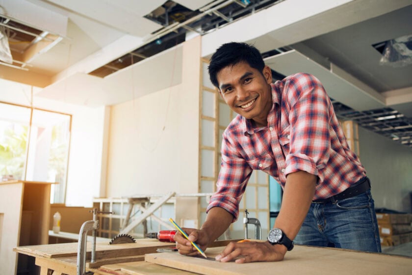 A confident small business owner busy with construction funded with a fixed-rate term loan.