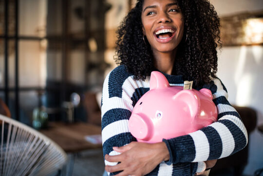 Woman is excited to be putting away savings with a chance to win even more with a Bonus Savings Account.