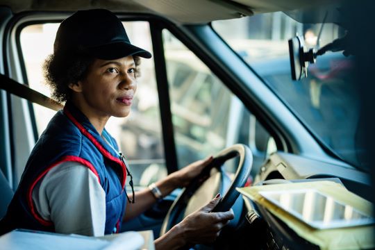 A woman drives a deliver van