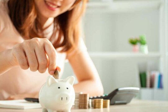 A woman calculates contributions into her Traditional IRA Account.