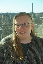 Headshot of Allison Green, Jeanne D'Arc Member Service Representative. She is a white woman with long medium-blonde hair. She's wearing glasses and smiling at the camera. 
