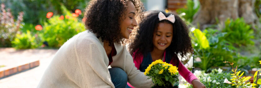 Happy mother and daughter planting flowers. family time, having fun together at home and garden