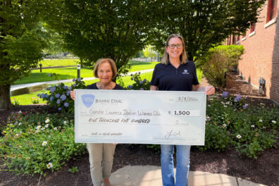 Phyllis Leary, Board Member and Charity Chairwoman of the Greater Lawrence Italian Women’s Club, standing with Alison Hughes, VP – Community Engagement of Jeanne D’Arc Credit Union, accepts a $1,500 check for being the Q2 2026 winner of the Give-A-Click campaign on July 8, 2026.