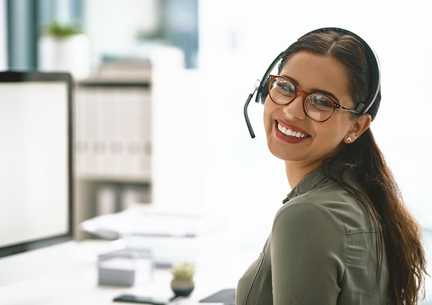 A woman at a service desk smiling