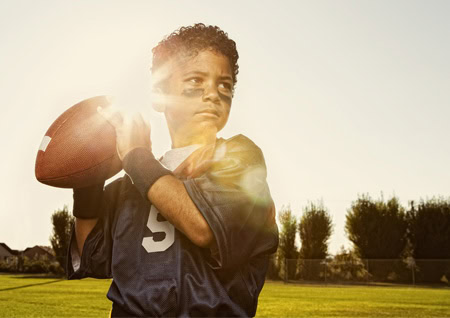 A portrait of a young flag football quarterback.