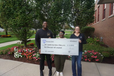 Representatives from The center for Hope and Healing from L-R: Arnold Johnson and Masada Jones accept a check from Alison Hughes, AVP-Community Engagement Officer, as the winner of Jeanne D’Arc’s 2023 third-quarter Give-A-Click Campaign