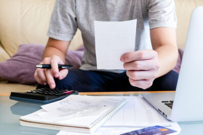 a man budgeting and calculating numbers to apply for a personal loan