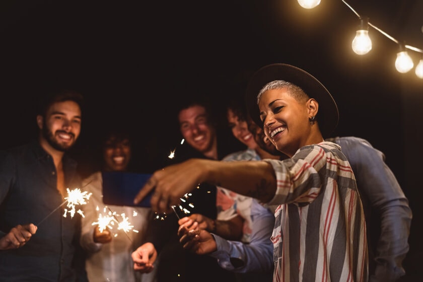 Happy group of friends lighting sparklers at a celebration. A Jeanne D'Arc Credit Union Personal Line of Credit can help you finance a celebration, consolidate debt, or pretty much anything else you can imagine.