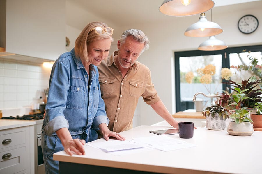 a couple considers their finances to refinance a home loan