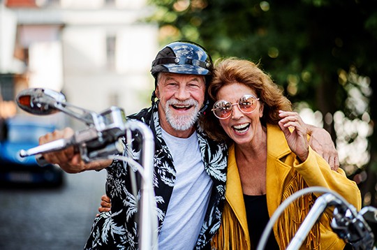 Couple smiling on motorcycle