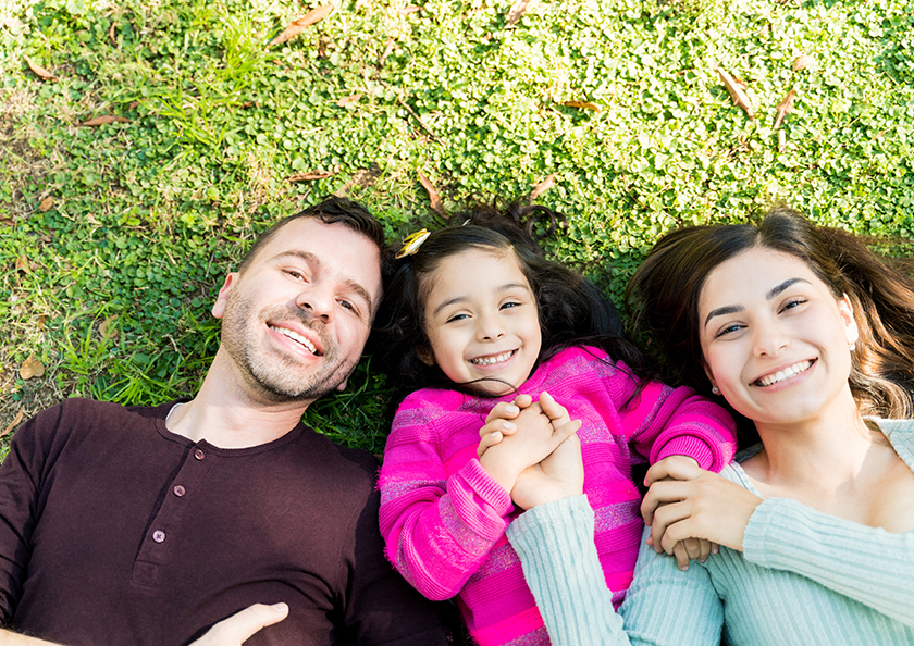 family-laying-on-grass-hero