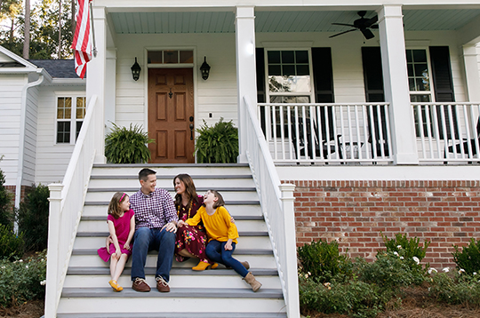 family-sitting-on-porch-mcti3