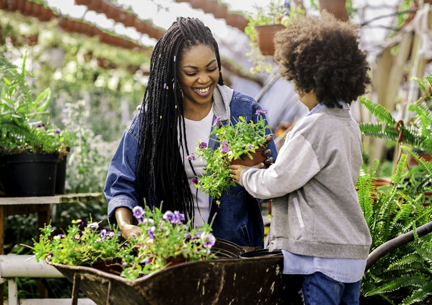 Mother and daughter working together in their greenhouse