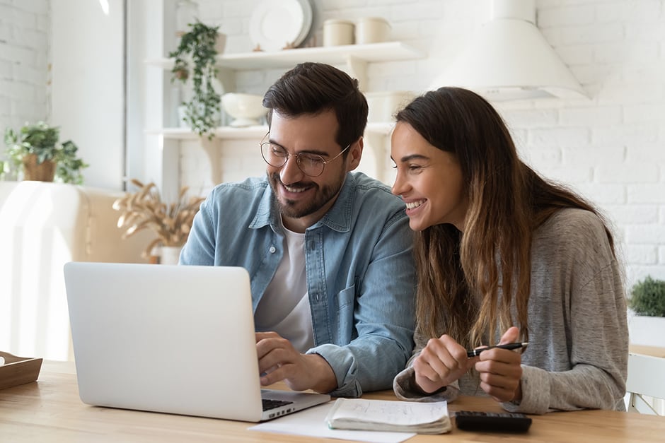 A couple looking at their laptop together