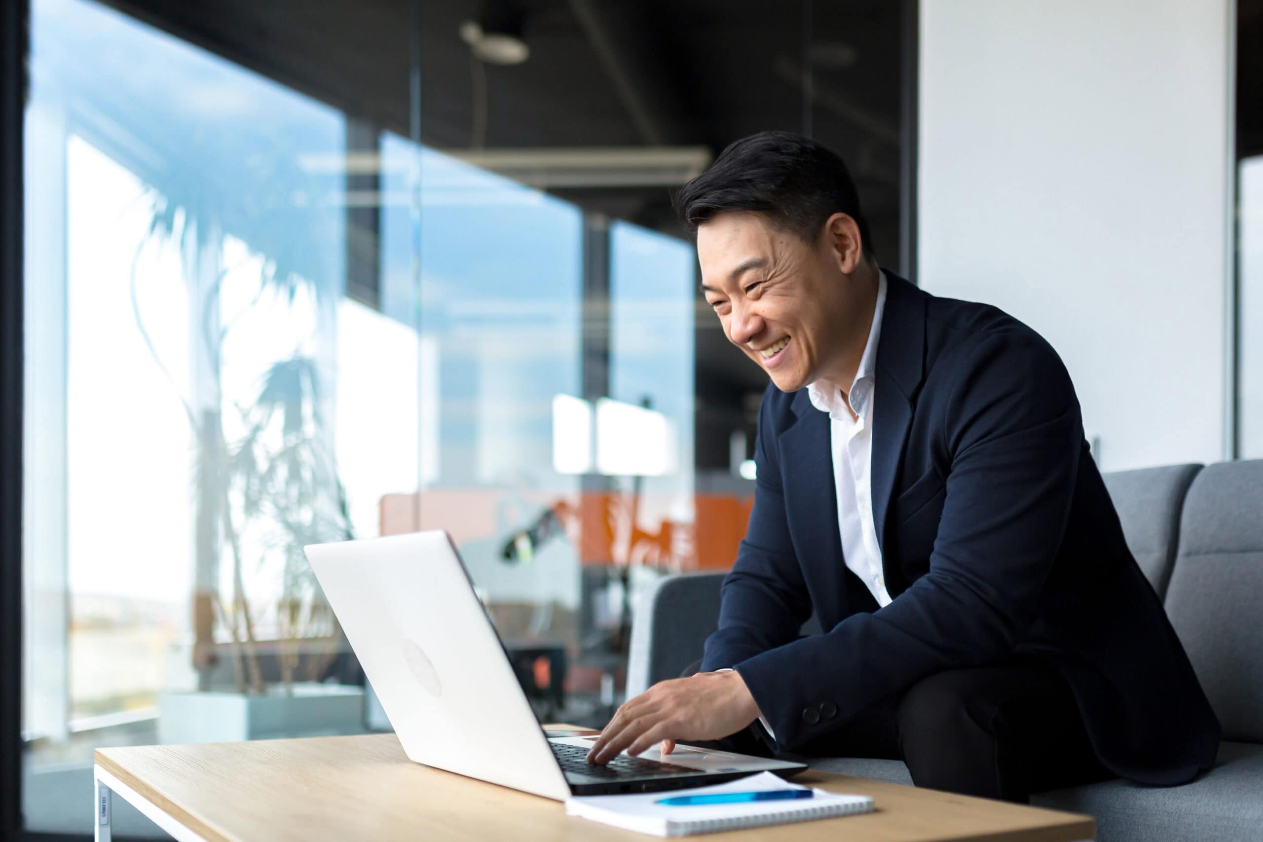 Senior Asian business man working on laptop online.