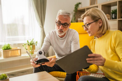 An older couple set up a security camera system in their home.