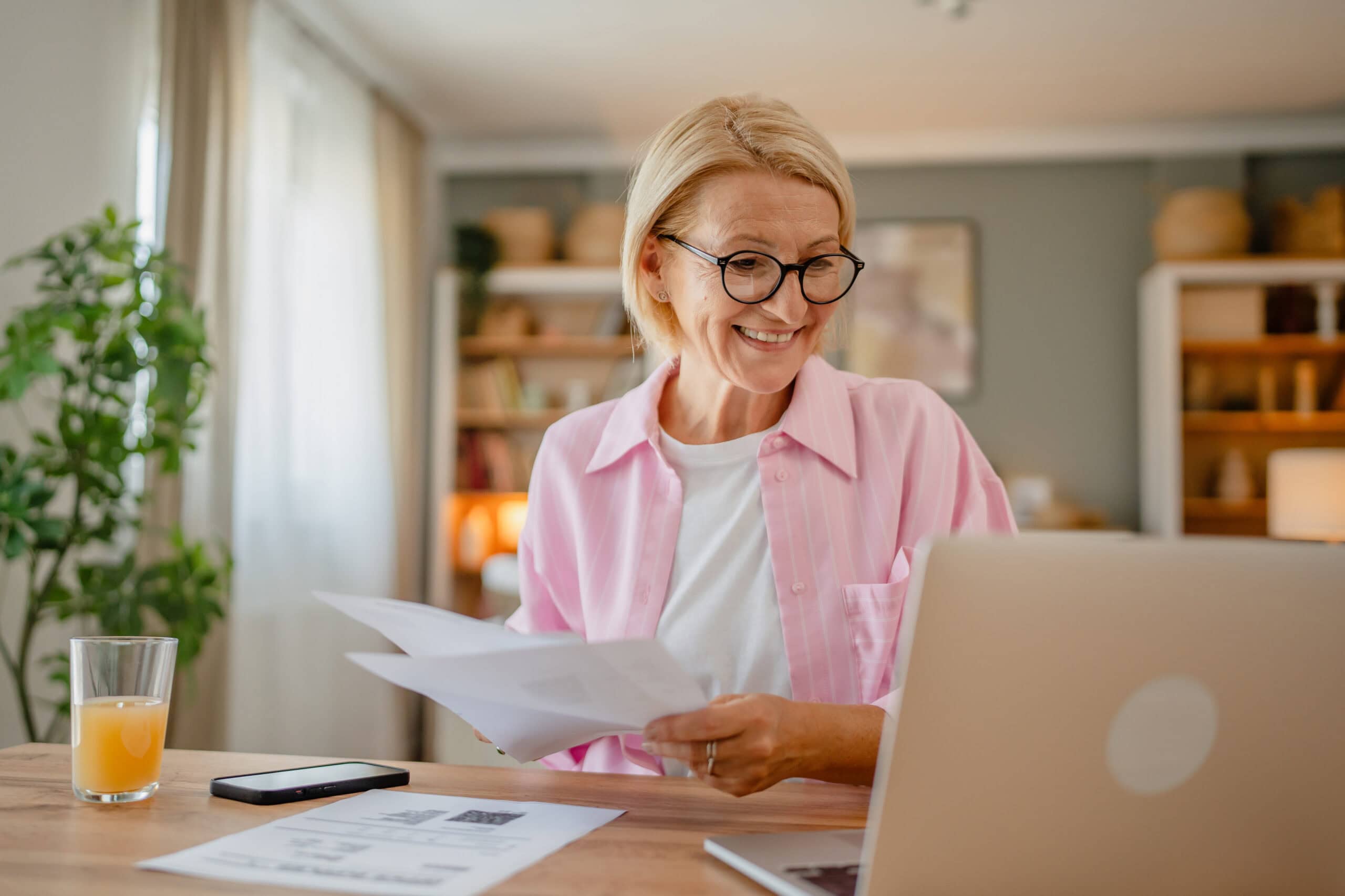 Older woman working on her finances on her laptop.
