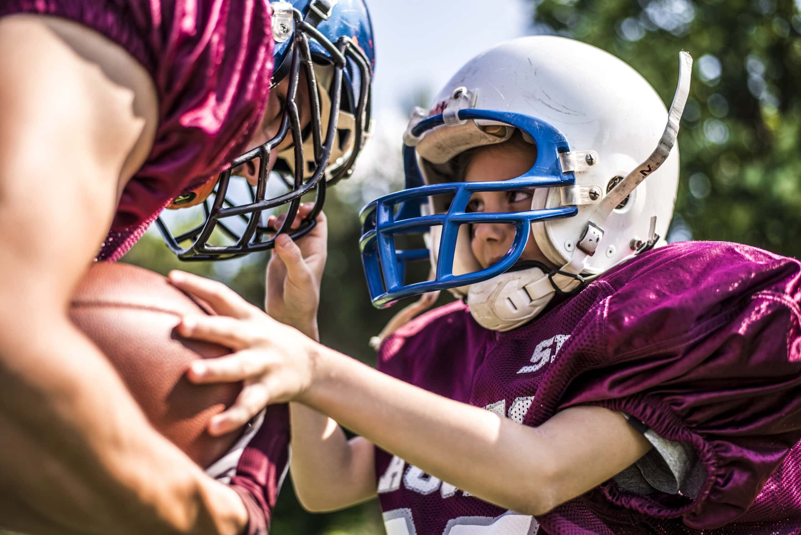 Little girl and her football coach on the field face to face