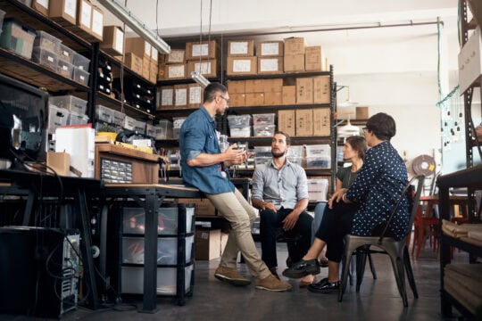 Manager leading a discussion with employees in a workshop